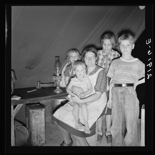 Untitled photo, possibly related to: Family of six in tent after supper. Came to potato harvest after father was laid off of WPA (Work Projects Administration) in Boise, Idaho. Oldest child is twelve. Little boy has dysentery. Merrill, Klamath County, Oregon. In FSA (Farm Security Administration) mo