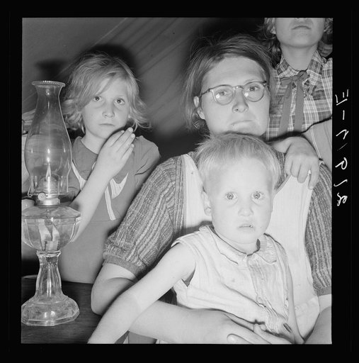 Family of six in tent after supper. Came to potato harvest after father was laid off of WPA (Work Projects Administration) in Boise, Idaho. Oldest child is twelve. Little boy has dysentery. Merrill, Klamath County, Oregon. In FSA (Farm Security Administration) mobile unit