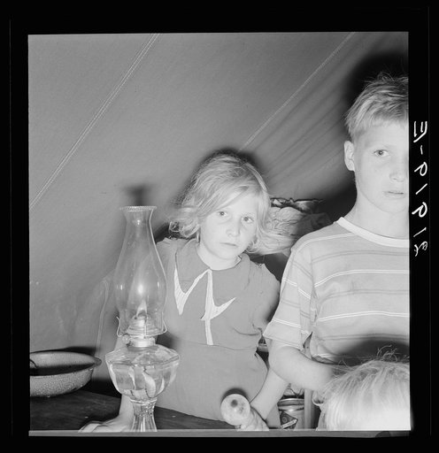 Untitled photo, possibly related to: Family of six in tent after supper. Came to potato harvest after father was laid off of WPA (Work Projects Administration) in Boise, Idaho. Oldest child is twelve. Little boy has dysentery. Merrill, Klamath County, Oregon. In FSA (Farm Security Administration) mo