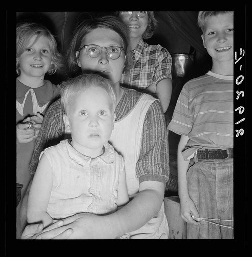 Untitled photo, possibly related to: Family of six in tent after supper. Came to potato harvest after father was laid off of WPA (Work Projects Administration) in Boise, Idaho. Oldest child is twelve. Little boy has dysentery. Merrill, Klamath County, Oregon. In FSA (Farm Security Administration) mo
