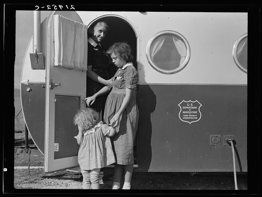 Young mother brings her child to the trailer clinic on the day when the doctor will be in camp to examine some of the children. Klamath County, Oregon. FSA (Farm Security Administration) camp