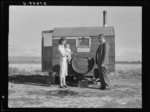 The doctor reassures the mother after having seen the sick baby in the trailer. Merrill, Klamath County, Oregon, at FSA (Farm Security Administration) mobile camp