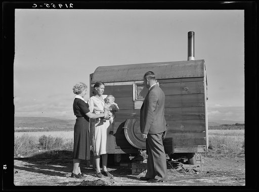 Untitled photo, possibly related to: The doctor reassures the mother after having seen the sick baby in the trailer. Merrill, Klamath County, Oregon, at FSA (Farm Security Administration) mobile camp
