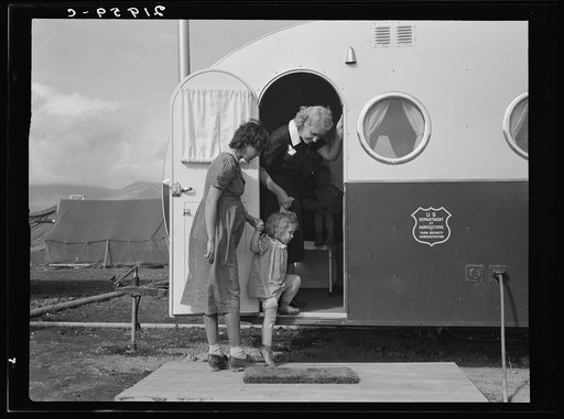 Untitled photo, possibly related to: Young mother brings her child to the trailer clinic on the day when the doctor will be in camp to examine some of the children. FSA (Farm Security Administration) mobile camp. Merrill, Klamath County, Oregon