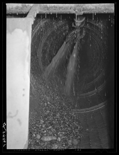 Untitled photo, possibly related to: Rocks coming out of gold dredge after ore has been removed. Nye County, Nevada