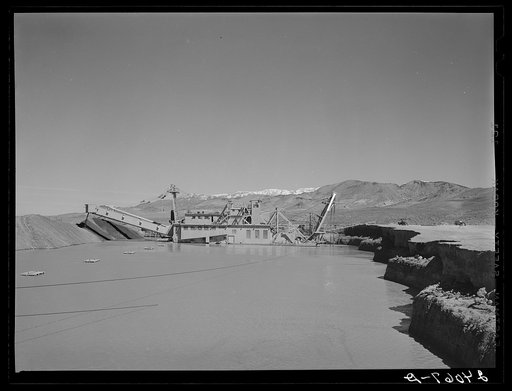 Gold dredge floats on artificial lake in the desert. Nye County, Nevada