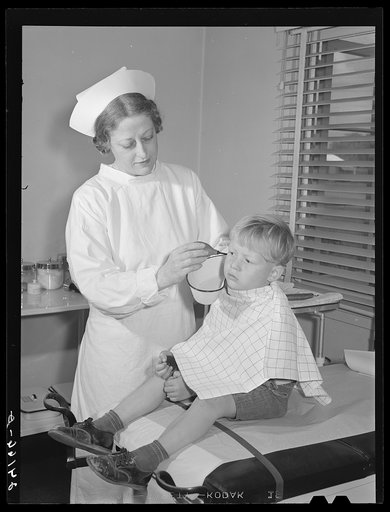 Child being treated in health clinic. Tulare migrant camp. Visalia, California