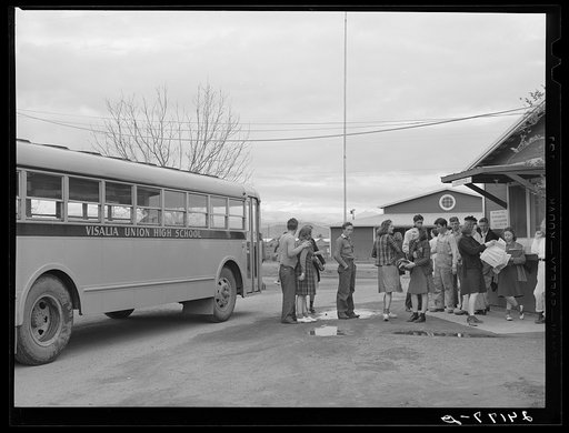 Migrant high school students arriving home from school. Tulare migrant camp. Visalia, California