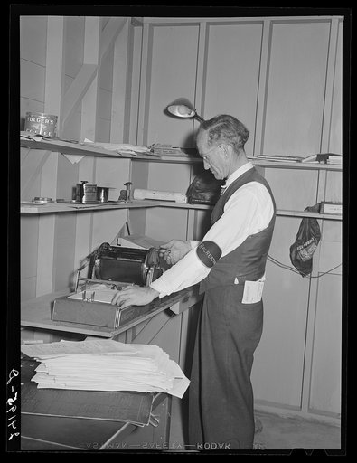 Putting out newspaper. Tulare migrant camp. Visalia, California