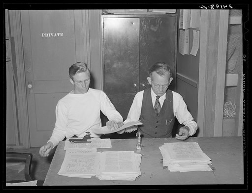 Putting out newspaper. Tulare migrant camp. Visalia, California