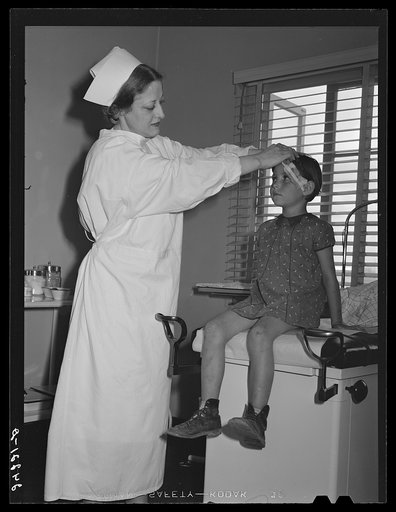 Nurse treating child in health clinic. Tulare migrant camp. Visalia, California