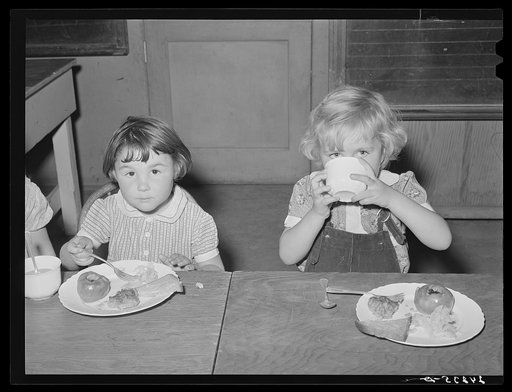 Children eating lunch in nursery. Tulare migrant camp. Visalia, California