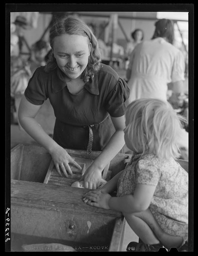 Woman washing clothes. Tulare migrant camp. Visalia, California