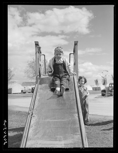 Untitled photo, possibly related to: Children on slide. Shafter migrant camp. Shafter, California