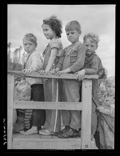 Children waiting their turn on slide. Shafter migrant camp. Shafter, California