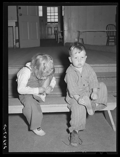 Nursery children putting on shoes after nap. Shafter migrant camp. Shafter, California