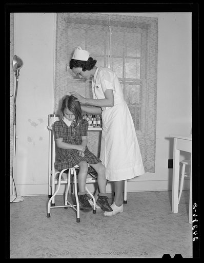Child being treated in health clinic. Shafter migrant camp. Shafter, California