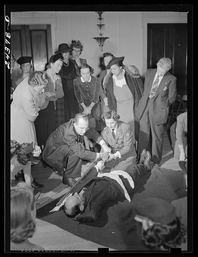 First aid class, American Red Cross, New York City. Demonstrating splint on fractured arm