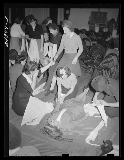 Untitled photo, possibly related to: First aid class, American Red Cross, New York City. Demonstrating splint on fractured arm