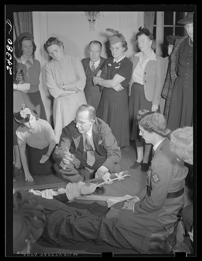 First aid class, American Red Cross, New York City. Demonstrating splint on fractured arm