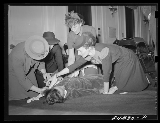 Untitled photo, possibly related to: Civilian Defense volunteers receiving instruction in treatment of fractured arm. First aid class. American Red Cross, New York City