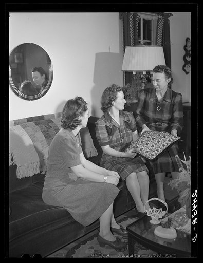 Mrs. Hardeman at home showing some of her handiwork to Miss Linger, project secretary. Dailey, West Virginia