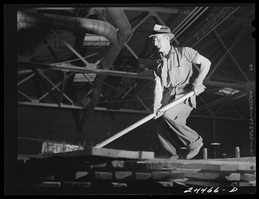 Untitled photo, possibly related to: Worker on lumber stacks. Dimension lumber plant. Dailey, West Virginia