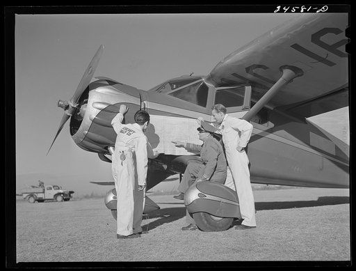 Instructor and students studying map. Civilian pilot training school. Meacham Field, Fort Worth, Texas