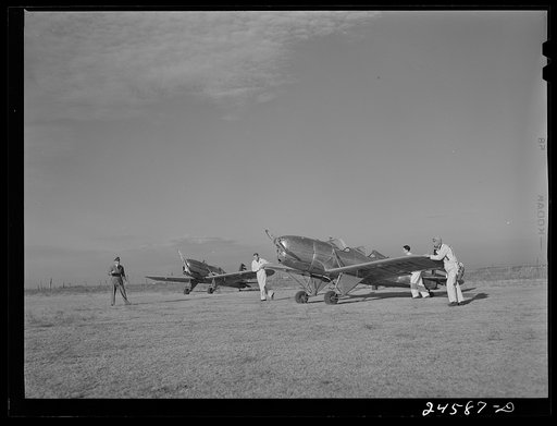 Students wheeling plane into position. Meacham Field, Fort Worth, Texas