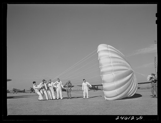 Instructor explaining operation of parachute to student pilots. Meacham Field, Fort Worth, Texas