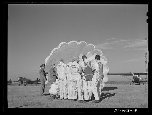 Untitled photo, possibly related to: Instructor explaining operation of parachute to student pilots. Meacham Field, Fort Worth, Texas