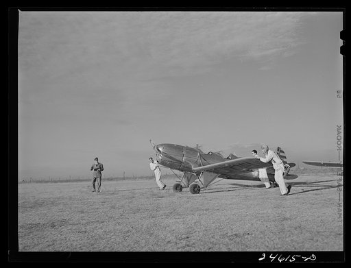 Fort Worth, Texas. Meacham Field. Student wheeling a plane into position