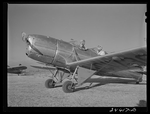 Untitled photo, possibly related to: Fort Worth, Texas. Meacham Field. Student wheeling a plane into position
