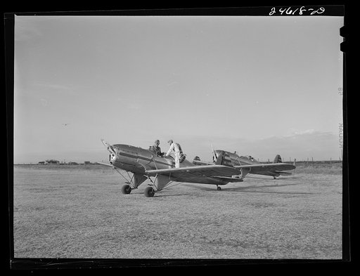 Untitled photo, possibly related to: Fort Worth, Texas. Meacham Field. Student wheeling a plane into position