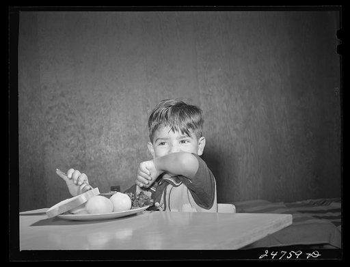 Latin-American child at lunch. Nursery school, FSA (Farm Security Administration) camp. Robstown, Texas