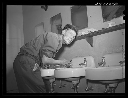 Farm worker in bathhouse. Robstown camp, Texas