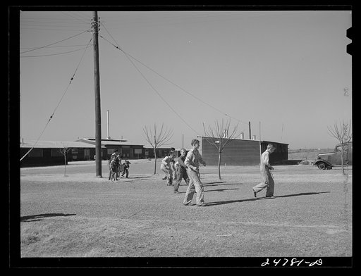 Boys cleaning up camp grounds on Saturday morning. Robstown camp, Texas