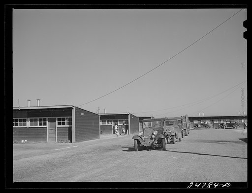Farm workers' cars and trucks parked near shelters. FSA (Farm Security Administration) camp, Robstown, Texas