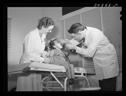 Doctor in clinic with young patient. Robstown FSA (Farm Security Administration) camp, Texas