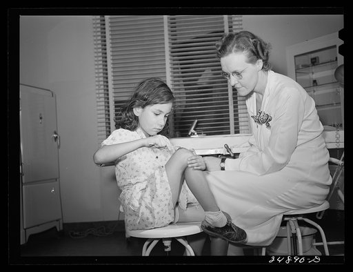 Untitled photo, possibly related to: Robstown, Texas. FSA (Farm Security Administration) migratory workers camp. Young patient treating injury under supervision of a nurse