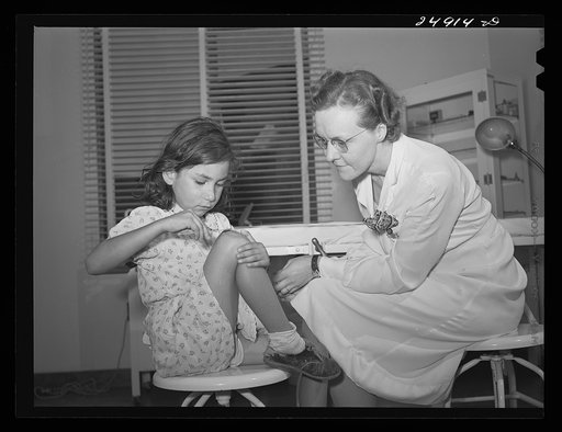 Robstown, Texas. FSA (Farm Security Administration) migratory workers camp. Young patient treating injury under supervision of a nurse