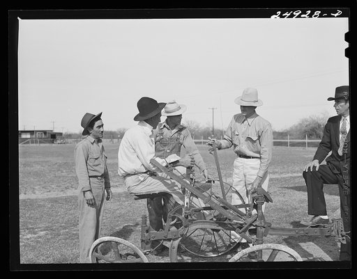 Untitled photo, possibly related to: Sinton, Texas. FSA (Farm Security Administration) camp. Community council examines new plow for use in community gardens