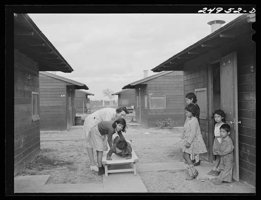 Untitled photo, possibly related to: Harlingen, Texas. FSA (Farm Security Administration) camp. Nurse taking a boy with a fractured leg out for air