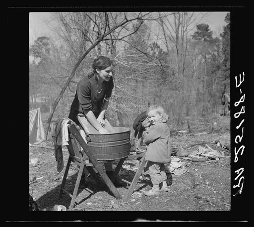 Washing clothes in a migrant camp near Birmingham, Alabama