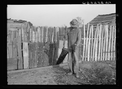 Gees Bend Negro splitting wood. Alabama