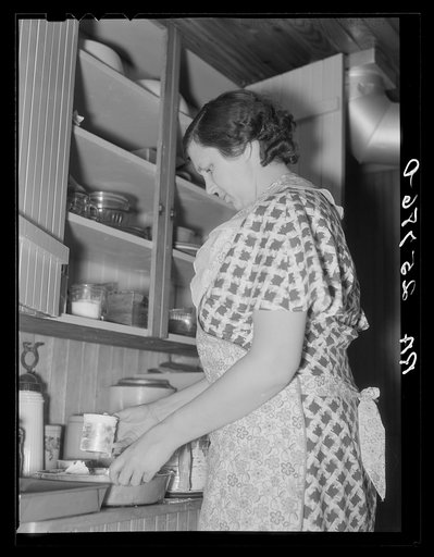 Mrs. McNally baking a cake for dinner. Kirby, Vermont