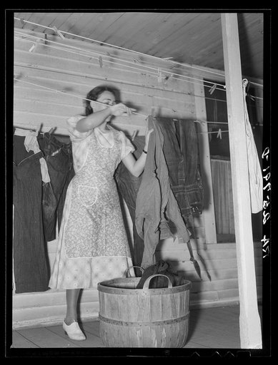 Hired girl taking in the washing. McNally farm, Kirby, Vermont