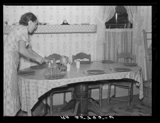 Hired girl setting the table. McNally farm, Kirby, Vermont