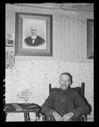 Fred Gleason with portrait of his father. Belfast, New York, Allegany County