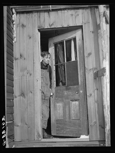 Fred Ess in the door of his farmhouse. Dalton, New York, Allegany County
